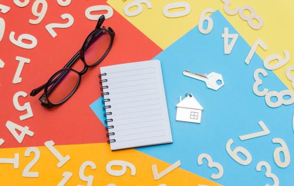 Numbers, a key, a house, spectacles and a notebook