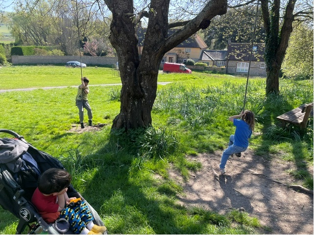 Maurice's children playing on a tree swing