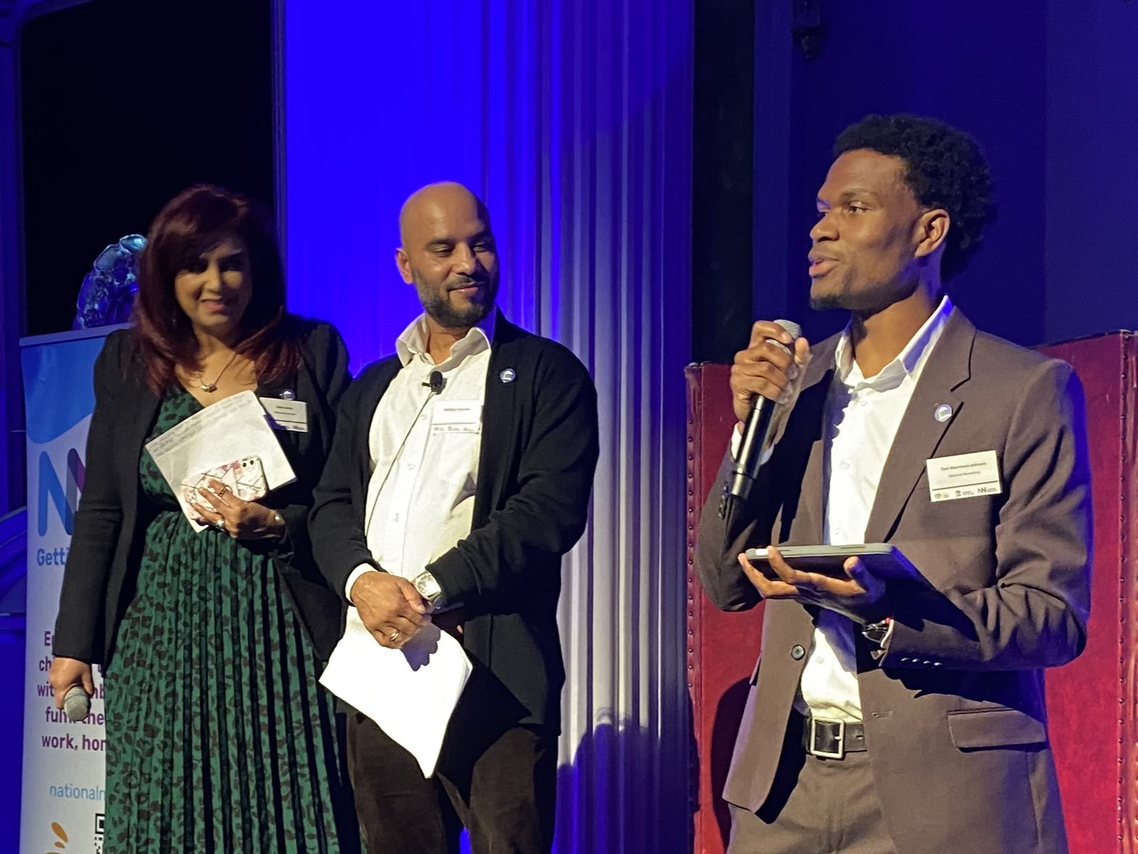 Nikki Chatha, Mokbul Hussain and Timi Merriman-Johnson on stage at the Impact Reception