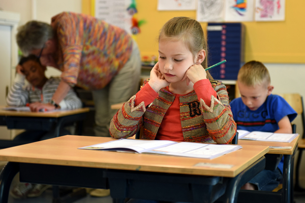 Child in a classroom represents the negative experiences at school which can bring on maths anxiety in later life