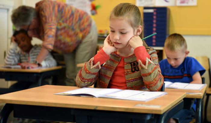 Child in a classroom represents the negative experiences at school which can bring on maths anxiety in later life