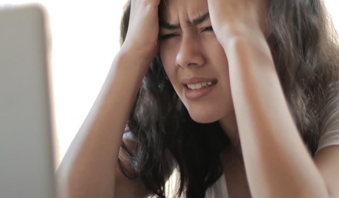 Stressed woman at laptop