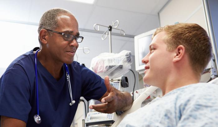 A doctor reassuring his patient.