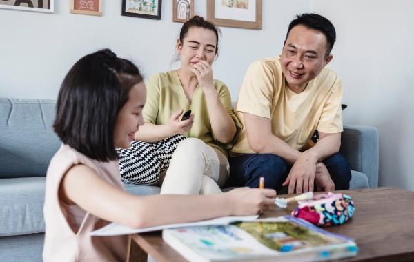 a child and her parents learning together