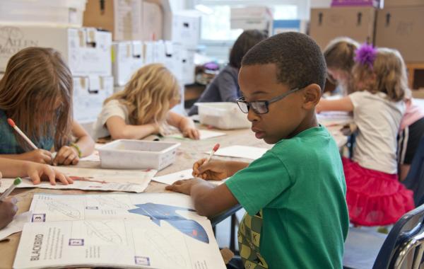 young school children studying at a desk