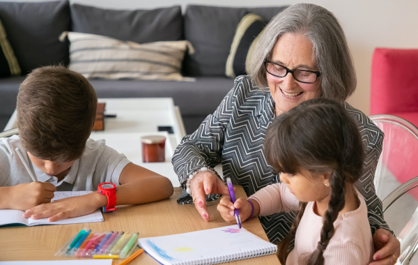 Older person helping children with homework