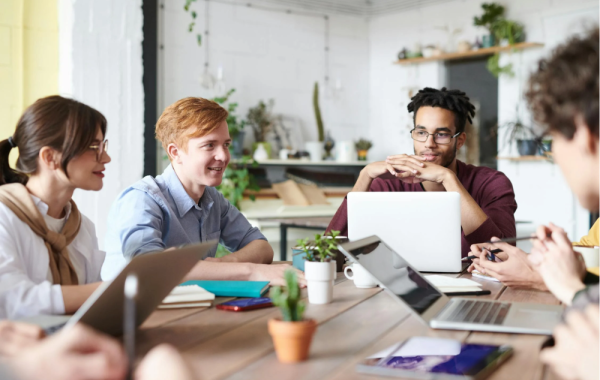 Photo of colleagues talking around a table