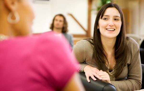 young woman chatting to another woman