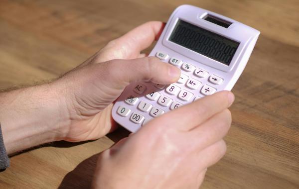 Person holding a calculator