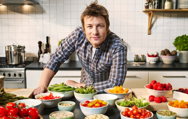 Photo of Jamie Oliver with bowls of food