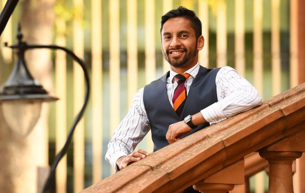 National Numeracy Ambassador Bobby Seagull standing on a staircase