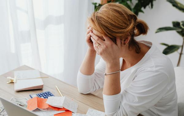 Person looking stressed with bills