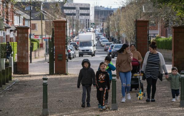 A shot of a street in Stoke-on-Trent with a family walking along the road