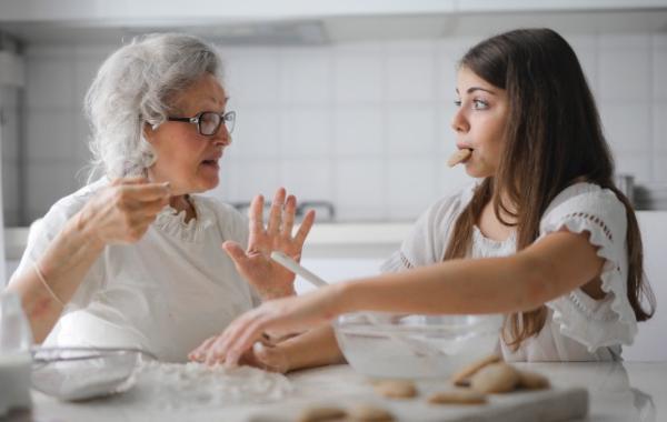 Grandparent and grandchild baking together