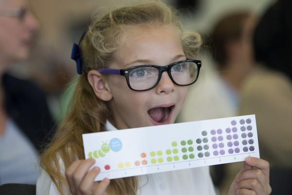 Photo of a young girl holding a National Numeracy number line