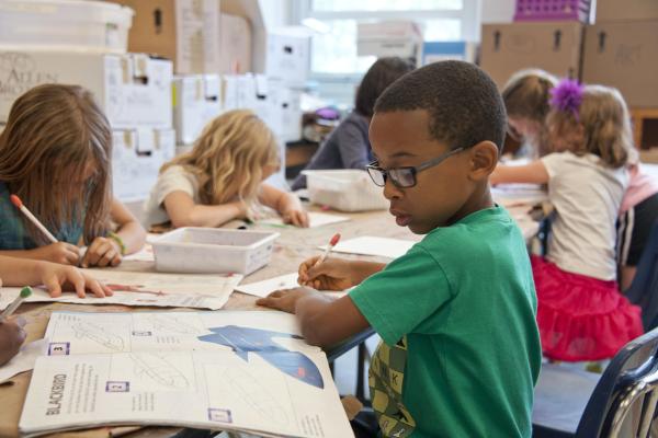 young school children studying at a desk