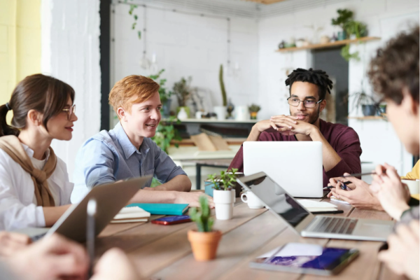 Photo of colleagues talking around a table