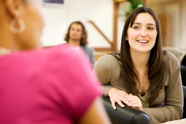 young woman chatting to another woman