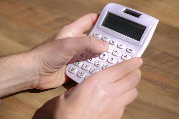 Person holding a calculator
