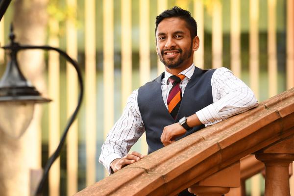 National Numeracy Ambassador Bobby Seagull standing on a staircase