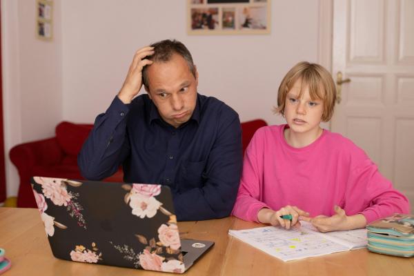 Parent and child struggling looking at a laptop