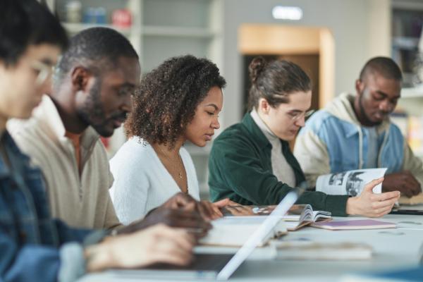 Five students are studying together at a table