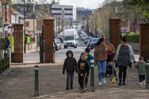 A shot of a street in Stoke-on-Trent with a family walking along the road